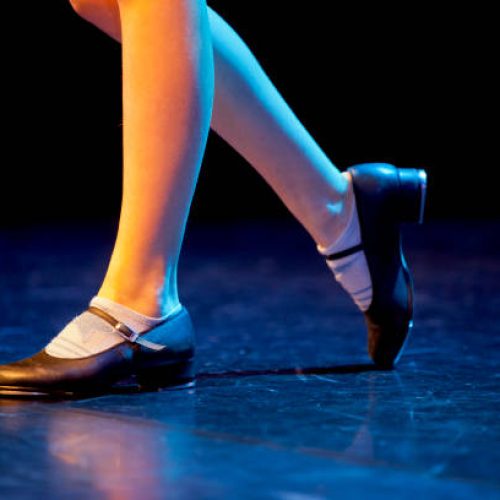 Image of tap shoes being used on a stage.